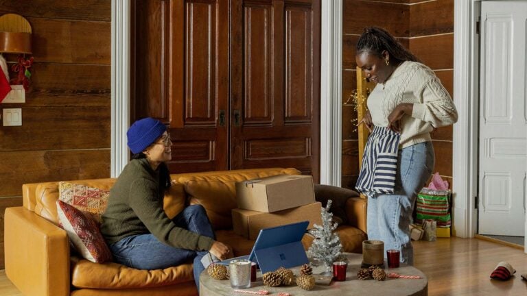 two friends looking at clothing ordered online.