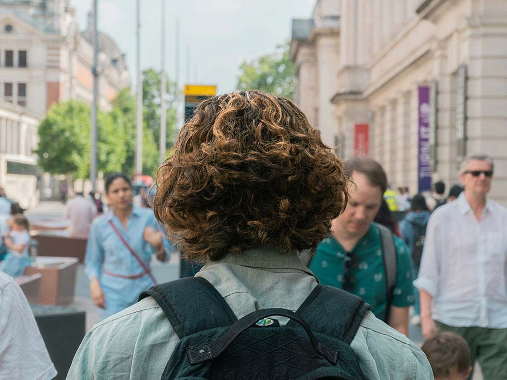 man walking down a crowded street.