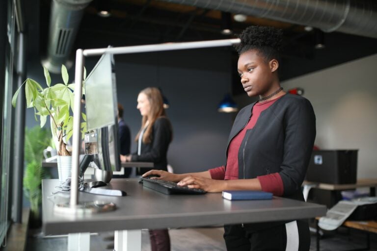 office workers at standing work station.