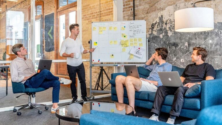 marketing team using whiteboard to layout a marketing strategy.